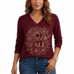 Women's long-sleeve V-neck cotton shirt featuring a gold VALE celestial sun, moon, and floral graphic design.