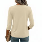 A woman wearing a breathable 3/4 sleeve cotton t-shirt with a colorful vertical "VALE" graphic print, available in cream, red, and black