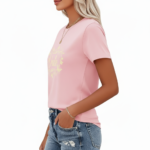 Woman wearing a breathable cotton t-shirt with a floral butterfly "VALE" graphic design on the chest, available in pink, red, and brown colors.