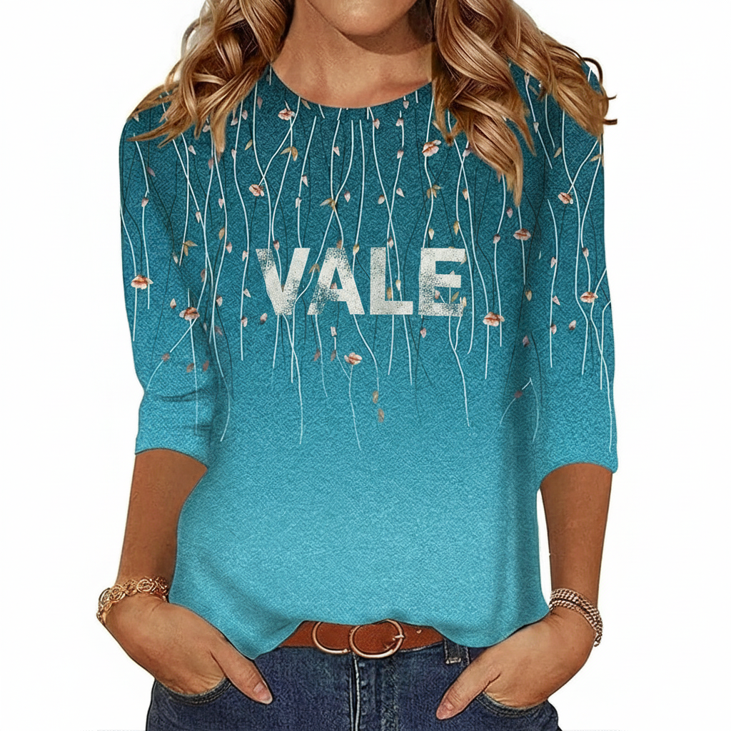 Women's breathable cotton graphic t-shirt featuring VALE floral vine print and ombre gradient design in Teal, Black, and Brown.