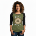 Woman wearing a breathable cotton raglan 3/4 sleeve shirt featuring a vintage nautical compass "VALE" graphic design, available in Grey/Black, White/Grey, and Olive/Black colorways.