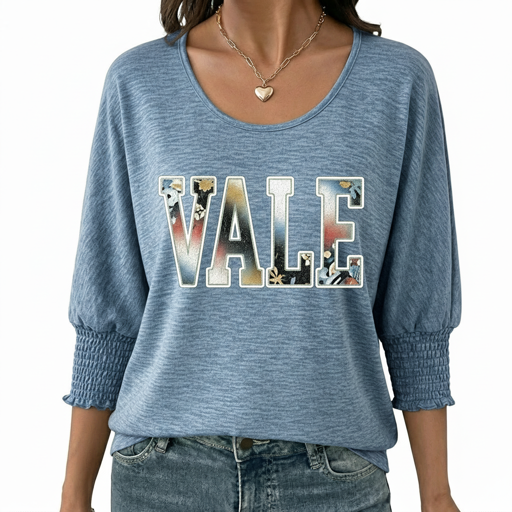 Women's breathable cotton VALE graphic top with floral lettering and smocked puff sleeves.