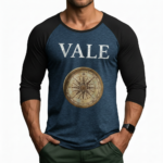 Men's 3/4 sleeve raglan baseball shirt in breathable cotton featuring a vintage VALE text and nautical compass graphic, athletic slim fit.