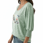 Women's breathable cotton VALE graphic top with floral lettering and smocked puff sleeves.