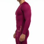 Front view of a man wearing a VALE brand long-sleeve compression shirt and matching leggings set in breathable fabric, available in white, navy blue, and maroon.