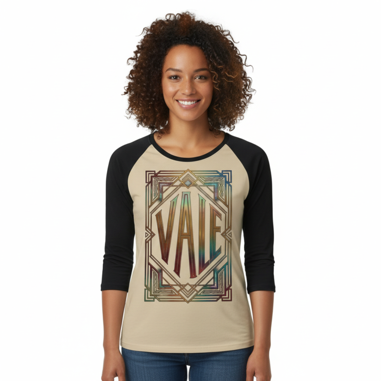 Woman wearing a VALE Art Deco graphic raglan shirt made of breathable cotton with black 3/4 sleeves, available in cream, maroon, and grey.