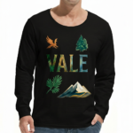 A man wearing a long-sleeve cotton shirt with a "VALE" nature graphic featuring a mountain, eagle, and tree, available in cream, black, and chocolate brown.