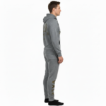 Rear and front view of a man wearing a VALE brand cotton tracksuit featuring a gold-foil vintage car and tree branch design on the back and vertical logo on the leg, shown on a white background.
