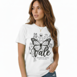 Woman wearing a Vale brand butterfly graphic t-shirt in brown, white, and maroon, featuring a vintage botanical butterfly design on 100% breathable cotton fabric.