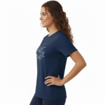 A female model showcasing the VALE branded floral graphic t-shirt in Navy Blue, Black, and White. 100% breathable cotton fabric featuring a silver script logo and elegant floral wreath design on a clean white background.