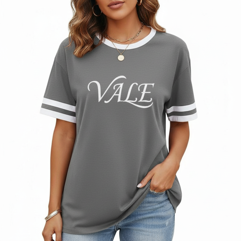 Woman wearing VALE graphic print ringer t-shirt in maroon, grey, and beige colors with varsity sleeve stripes.