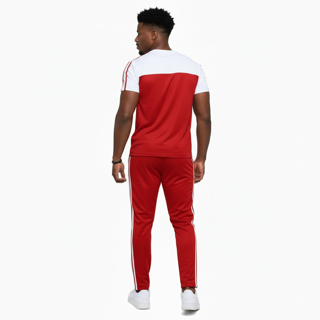 Man wearing VALE brand two-tone cotton tracksuit set in orange, red, and green with white accents and "key in hand" logo.