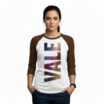Person wearing a 3/4 sleeve raglan cotton shirt featuring a vertical VALE galaxy-textured graphic print.