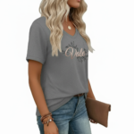 Woman wearing a "Vale" floral print V-neck cotton t-shirt with a chest pocket, available in blue, red, and grey.