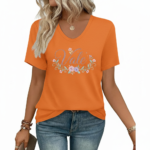 A woman wearing a breathable cotton V-neck t-shirt with a floral "Vale" graphic design, available in orange, khaki, and olive green colors.