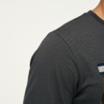 Men's long sleeve cotton shirt featuring a realistic mechanical watch gear "VALE" graphic print, available in orange, charcoal, and olive green.