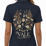 Back view of a premium cotton polo shirt featuring a VALE celestial graphic with moon phases, moths, and botanical ferns in vintage gold tones on black, navy, and maroon fabric.