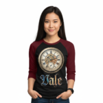 Young woman wearing a Vale Steampunk Clockwork graphic raglan shirt in 3/4 sleeves, made of breathable cotton, available in maroon, grey, and navy colorways.