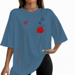 Woman wearing an oversized breathable cotton t-shirt with a red rose graphic and vertical text, available in black, slate blue, and sand beige colors.