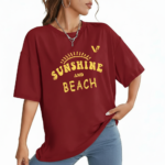 Woman wearing a breathable cotton oversized t-shirt with "Sunshine and Beach" yellow graphic print, available in navy blue, maroon, and red.
