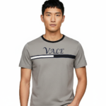 Close-up of a man wearing a VALE branded 100% cotton breathable slim-fit t-shirt with a horizontal chest stripe, available in grey, white, and maroon.