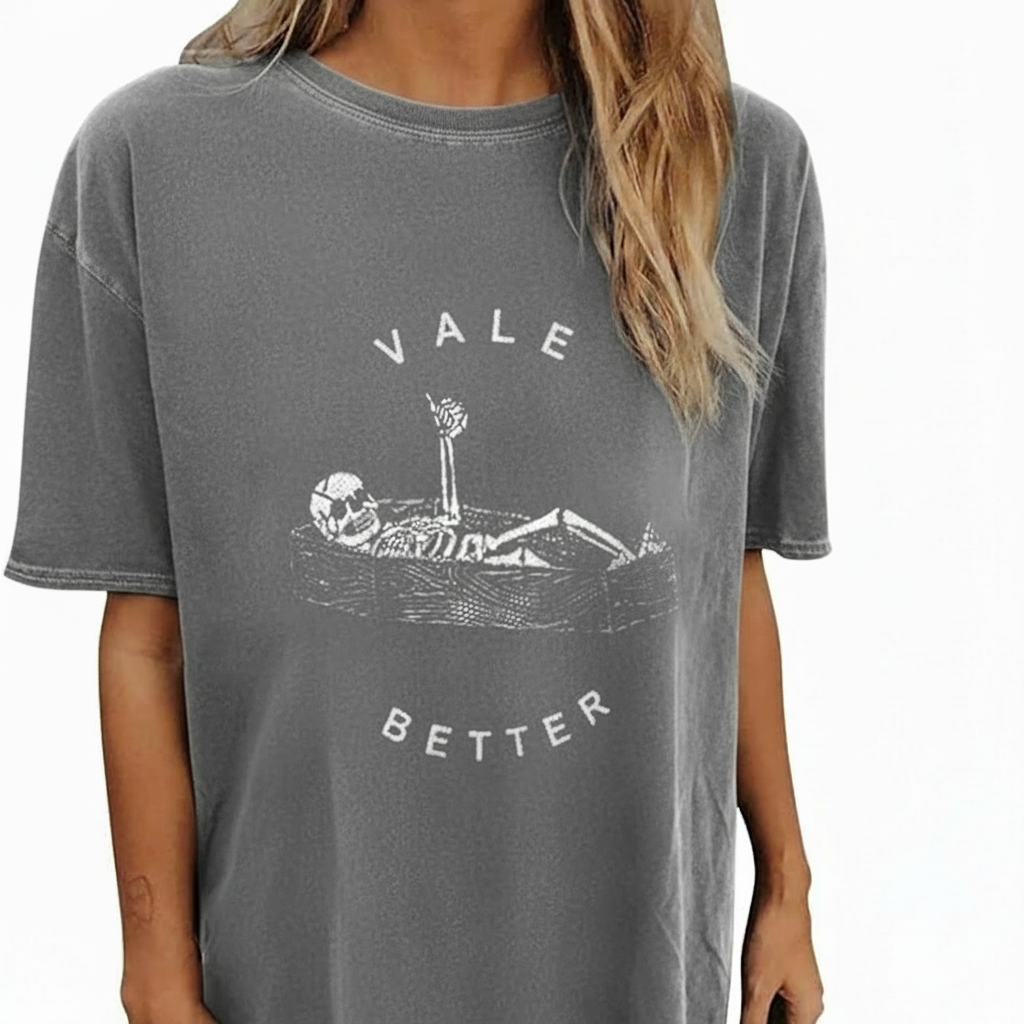 Vale Better Skeleton Graphic T-Shirt Oversized vintage washed cotton t-shirt featuring a skeleton lying in a coffin with "VALE BETTER" text, available in charcoal black, maroon burgundy, and slate gray.