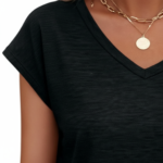 Woman wearing a VALE branded breathable cotton V-neck t-shirt in [Insert Color: Blue/Black/Orange], paired with denim jeans, showcasing a casual summer outfit.