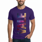 A man wearing a slim-fit 100% cotton t-shirt with a vertical 'VALE' graphic in a vibrant purple, gold, and blue metallic texture.