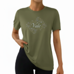 A woman wearing a premium breathable cotton t-shirt featuring the "Vale" brand logo in white script surrounded by a floral wreath with pink roses. Available in forest green, mustard orange, and cream beige colors.