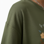 Front view of a woman wearing an oversized breathable cotton t-shirt with a vintage wildflower graphic print, available in blue, green, and orange.