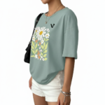 Women's oversized breathable cotton t-shirt featuring a vintage daisy floral print in sage green, brown, and red colors.