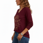 Women's long-sleeve V-neck cotton shirt featuring a gold VALE celestial sun, moon, and floral graphic design.