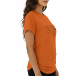 Woman wearing a VALE brand graphic t-shirt in breathable cotton, featuring a minimalist leaf design and athletic slim fit. Available in Black, Purple, and Orange.