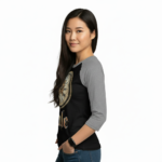 Young woman wearing a Vale Steampunk Clockwork graphic raglan shirt in 3/4 sleeves, made of breathable cotton, available in maroon, grey, and navy colorways.