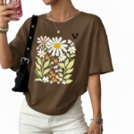 Women's oversized breathable cotton t-shirt featuring a vintage daisy floral print in sage green, brown, and red colors.