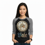 Young woman wearing a Vale Steampunk Clockwork graphic raglan shirt in 3/4 sleeves, made of breathable cotton, available in maroon, grey, and navy colorways.