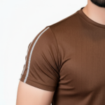 Full-body view of a man wearing the VALE brand breathable cotton activewear set, featuring a vertical logo t-shirt and matching side-striped joggers on a white background.