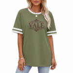 Woman wearing a VALE branded varsity t-shirt made of breathable cotton with white sleeve stripes and a vintage filigree logo, available in beige, olive, and brown.