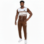 Man wearing a VALE brand breathable cotton tracksuit featuring a forest landscape and key graphic print on the shirt with matching striped track pants.