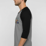 Men's VALE patchwork raglan shirt in white, grey, and cream with black and brown 3/4 sleeves, featuring decorative textured lettering.