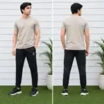 Men wearing beige t-shirt with black track pants sportswear outfit standing outdoors