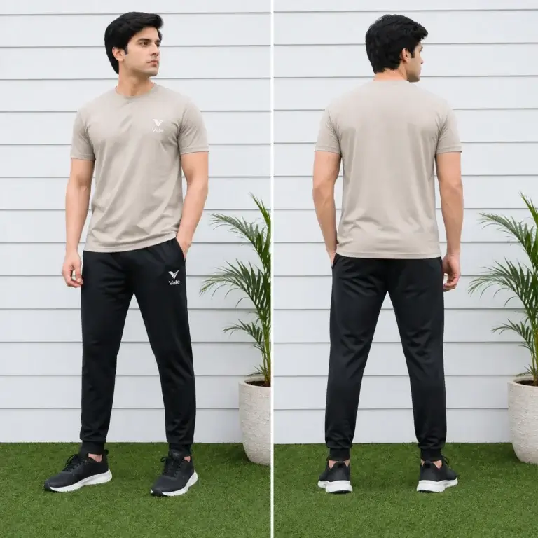 Men wearing beige t-shirt with black track pants sportswear outfit standing outdoors