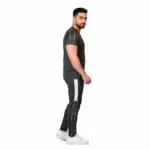 Front and back view of a man wearing the VALE brand breathable cotton performance tracksuit, featuring a vertical outline logo on the t-shirt back and matching side-striped joggers on a white background.