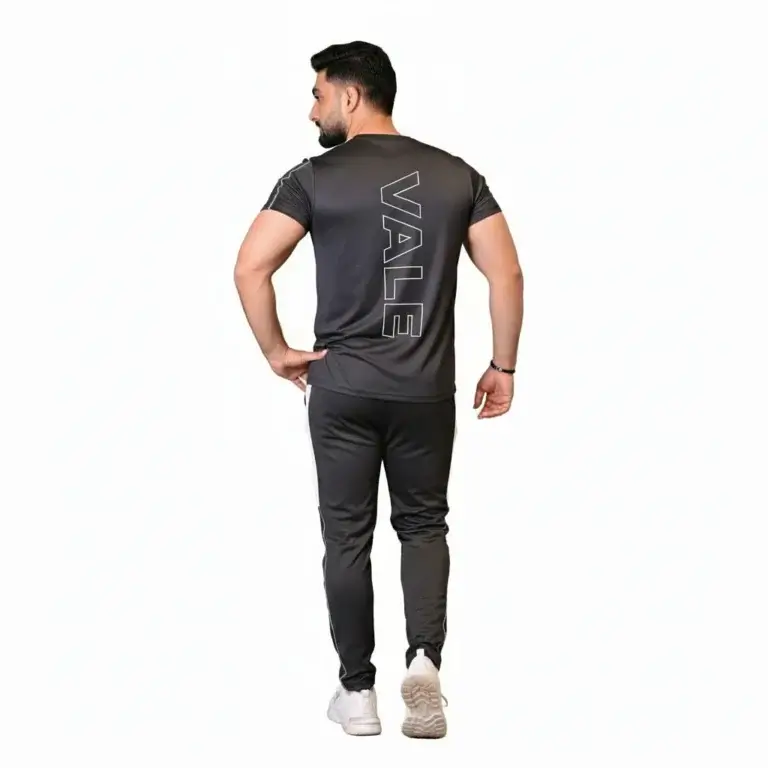 Front and back view of a man wearing the VALE brand breathable cotton performance tracksuit, featuring a vertical outline logo on the t-shirt back and matching side-striped joggers on a white background.