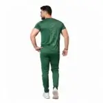 Front and back view of a man wearing the VALE brand breathable cotton performance tracksuit, featuring a vertical outline logo on the t-shirt back and matching side-striped joggers on a white background.